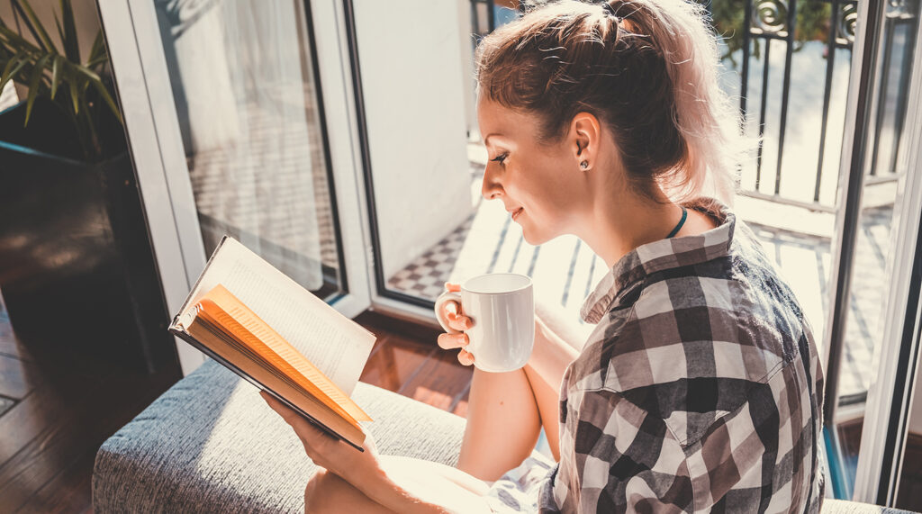 Young woman enjoys reading a book.