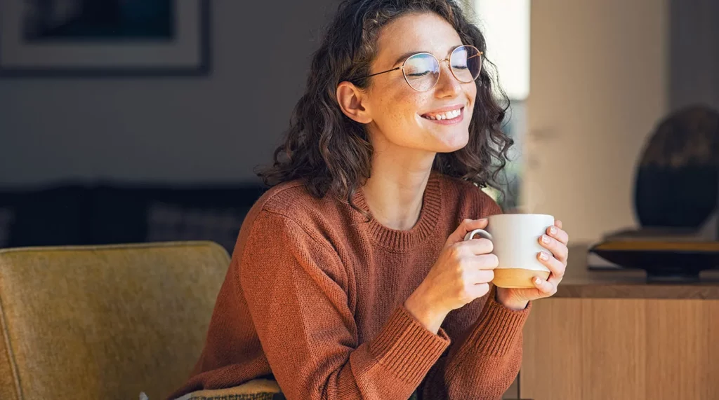 Young woman enjoys a cup of coffee